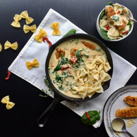 Creamy Tuscan Chick'un: Gourmet pasta dish that's perfect for holidays, special occasion or just a weeknight dinner. Cooked golden, crisp chicken-less bites served in a delicate, creamy garlic sauce with spinach and sun dried tomatoes over tender pasta. A perfect home cooked meal full of flavor ready to serve in under 30min.
