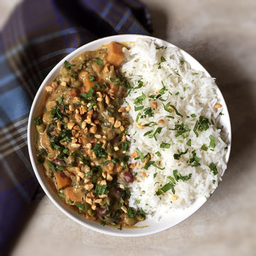 African Peanut Stew:A hearty, lightly spicy, earthy, delicious, protein loaded and all time favorite peanut African Stew. Potatoes, carrots, celery. beans, and green peas simmered in tomato peanut-butter sauce, with splash of coconut milk, served over basmati rice.
